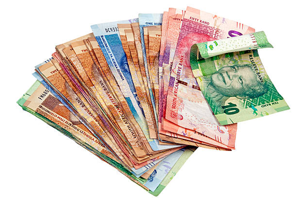 Above view of isolated spread South African Rand notes on white